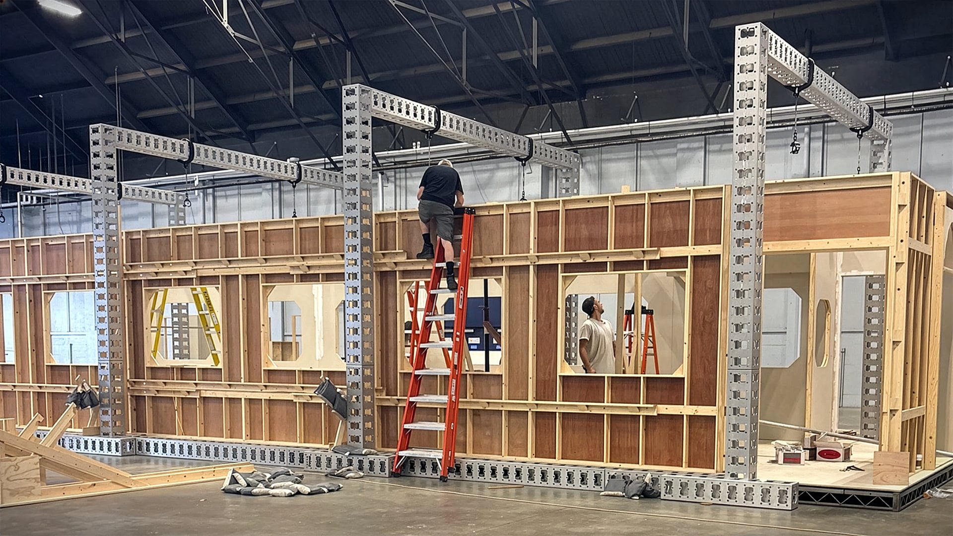 Train cabin wall framing with plywood and metal supports under construction in warehouse for MGM Grand